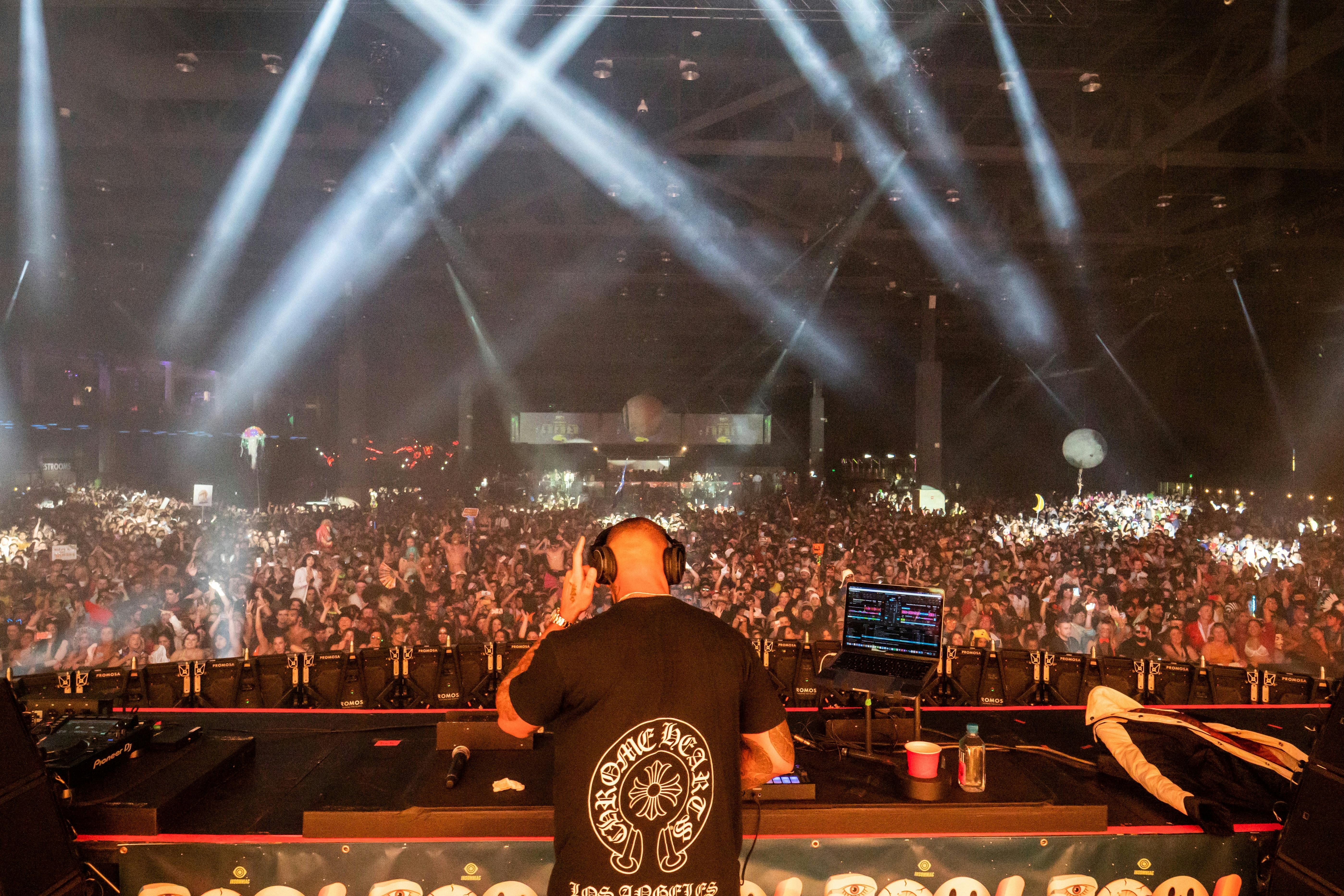 DJ performing live on stage neon lights